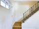 Inviting entryway with hardwood floors, stairway, and a charming wrought iron railing at 8770 Rainbow Ave # B4, Denver, CO 80229