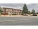 A charming two-story townhome features a neutral exterior, a small porch, and a well-maintained front yard at 8770 Rainbow Ave # B4, Denver, CO 80229