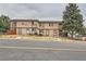 A charming two-story townhome features a neutral exterior, a small porch, and a well-maintained front yard at 8770 Rainbow Ave # B4, Denver, CO 80229
