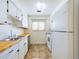 A well-lit kitchen features white cabinets, wood countertops, and modern appliances at 8770 Rainbow Ave # B4, Denver, CO 80229