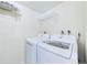 Bright laundry room featuring modern washer and dryer appliances and wire shelving for storage at 8770 Rainbow Ave # B4, Denver, CO 80229