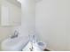 Clean powder room with a classic white sink, toilet, and mirror, offering a functional space at 8770 Rainbow Ave # B4, Denver, CO 80229