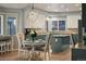 Cozy breakfast nook area with a table and chairs next to a modern kitchen featuring an island at 5426 S Jasper Way, Centennial, CO 80015