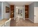 Home office with custom built-in shelving, a view into another room, and a modern color palette at 5426 S Jasper Way, Centennial, CO 80015