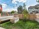 Landscaped backyard with fire pit and wooden seating at 9618 W Chatfield Ave # E, Littleton, CO 80128