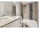 Bathroom with a shower/tub combo, granite vanity and gray tile at 9618 W Chatfield Ave # E, Littleton, CO 80128