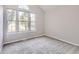 Bright bedroom with gray carpet and arched window at 9618 W Chatfield Ave # E, Littleton, CO 80128