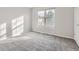 Bright bedroom with grey carpet and large windows at 9618 W Chatfield Ave # E, Littleton, CO 80128