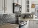 Kitchen detail showing granite countertops and gray Moroccan-patterned backsplash at 9618 W Chatfield Ave # E, Littleton, CO 80128