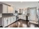 Bright kitchen with granite countertops, white cabinets, and dark hardwood floors at 9618 W Chatfield Ave # E, Littleton, CO 80128