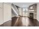 Living room with hardwood floors, fireplace and staircase at 9618 W Chatfield Ave # E, Littleton, CO 80128