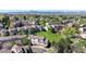 Scenic aerial view of townhomes with lush green spaces and mountain views in the distance at 6809 S Webster St # F, Littleton, CO 80128