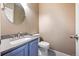 Charming half-bath with unique blue vanity and granite countertop at 6809 S Webster St # F, Littleton, CO 80128