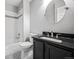 Modern bathroom with a dark vanity and tub at 6809 S Webster St # F, Littleton, CO 80128