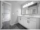 Bathroom featuring a large mirror and double sink vanity at 6809 S Webster St # F, Littleton, CO 80128