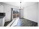 Bright dining area with hardwood floors, contemporary lighting, and sliding glass doors to the outside at 6809 S Webster St # F, Littleton, CO 80128