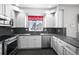 Modern kitchen with stainless steel appliances, granite countertops, tile backsplash and white cabinets at 6809 S Webster St # F, Littleton, CO 80128