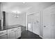 Convenient laundry area adjacent to the kitchen and a dining area with contemporary chandelier at 6809 S Webster St # F, Littleton, CO 80128