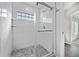 Beautifully tiled walk-in shower with glass door and accent window at 6809 S Webster St # F, Littleton, CO 80128