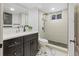 Bathroom with a glass shower, black cabinets and modern fixtures at 982 S Holly St, Denver, CO 80246