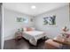 Bright bedroom with hardwood floors, two windows and a comfortable bed at 982 S Holly St, Denver, CO 80246