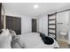 Comfortable bedroom with a modern barn door leading to the bathroom at 982 S Holly St, Denver, CO 80246