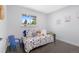 Well-lit bedroom featuring stylish decor, including a plush daybed and hardwood floors at 982 S Holly St, Denver, CO 80246
