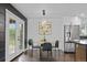 Cozy dining area with modern lighting and a view of the backyard at 982 S Holly St, Denver, CO 80246