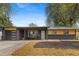 Charming exterior of a brick home featuring a modern garage and inviting front porch at 982 S Holly St, Denver, CO 80246