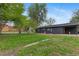 Expansive backyard view of home and lush green lawn at 982 S Holly St, Denver, CO 80246