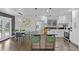 Modern kitchen with stainless steel appliances, black countertops, and a stylish island at 982 S Holly St, Denver, CO 80246