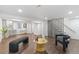 Open-concept living room features hard wood floors, wet bar and modern staircase at 982 S Holly St, Denver, CO 80246