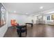 Basement living room features a wet bar, modern furniture and hardwood flooring at 982 S Holly St, Denver, CO 80246