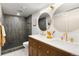 Elegant bathroom featuring dual sinks, gold accents, a walk-in shower with modern tile at 1029 N Columbine St, Golden, CO 80403