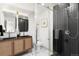 Modern bathroom featuring a dual vanity, sleek fixtures, and a glass-enclosed shower with dark tile at 1029 N Columbine St, Golden, CO 80403