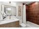 Stylish bathroom featuring a modern vanity, gold fixtures, and a tiled shower with a white shower curtain at 1029 N Columbine St, Golden, CO 80403