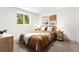 Serene bedroom with a metal frame bed, warm tones, and natural light from a window at 1029 N Columbine St, Golden, CO 80403