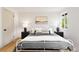 Cozy bedroom featuring a white metal frame bed, dark nightstands and hardwood floors at 1029 N Columbine St, Golden, CO 80403