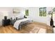 Bright bedroom with a white metal bed frame, natural light, and hardwood floors at 1029 N Columbine St, Golden, CO 80403