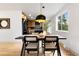 Dining space with modern table and chairs, next to an open kitchen with stainless steel appliances at 1029 N Columbine St, Golden, CO 80403