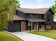 A modern two-story home with a brick facade, dark paint, and a well-manicured front lawn at 1029 N Columbine St, Golden, CO 80403