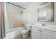 Bathroom featuring shower, white cabinets, and large mirror at 9175 Cole Dr, Arvada, CO 80004
