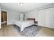 Bedroom with light gray walls, wood flooring, and closet at 9175 Cole Dr, Arvada, CO 80004