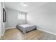Minimalist bedroom with wood floors, a double bed, and simple furnishings at 9175 Cole Dr, Arvada, CO 80004