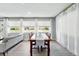 Sunlit dining room with wood table, chairs, neutral walls, and large windows at 9175 Cole Dr, Arvada, CO 80004