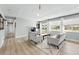 Spacious living room with light gray walls, wood flooring, and french doors at 9175 Cole Dr, Arvada, CO 80004
