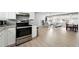 View of open concept living space from kitchen area with modern oven at 9175 Cole Dr, Arvada, CO 80004
