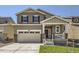 Charming two-story home featuring a welcoming front porch and a two-car garage at 16686 E 110Th Ave, Commerce City, CO 80022