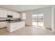 Stylish kitchen features an island, white cabinets, stainless steel appliances, and backyard access at 16686 E 110Th Ave, Commerce City, CO 80022