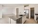 Open-concept kitchen with stainless steel appliances, an island, and views of the living area at 16686 E 110Th Ave, Commerce City, CO 80022